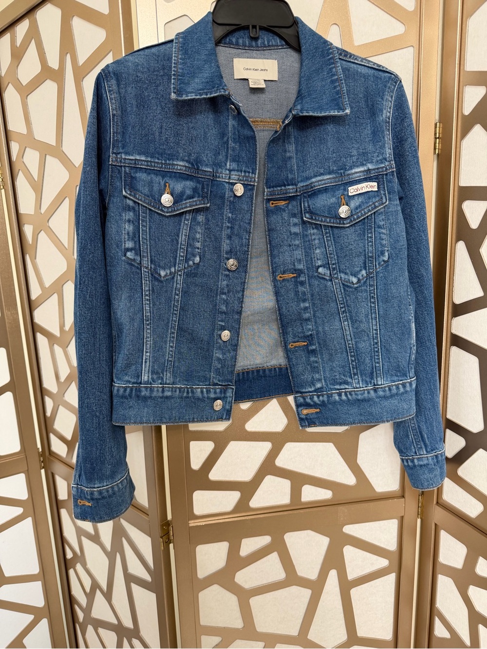 Calvin Klein Jeans classic medium-wash denim trucker jacket.